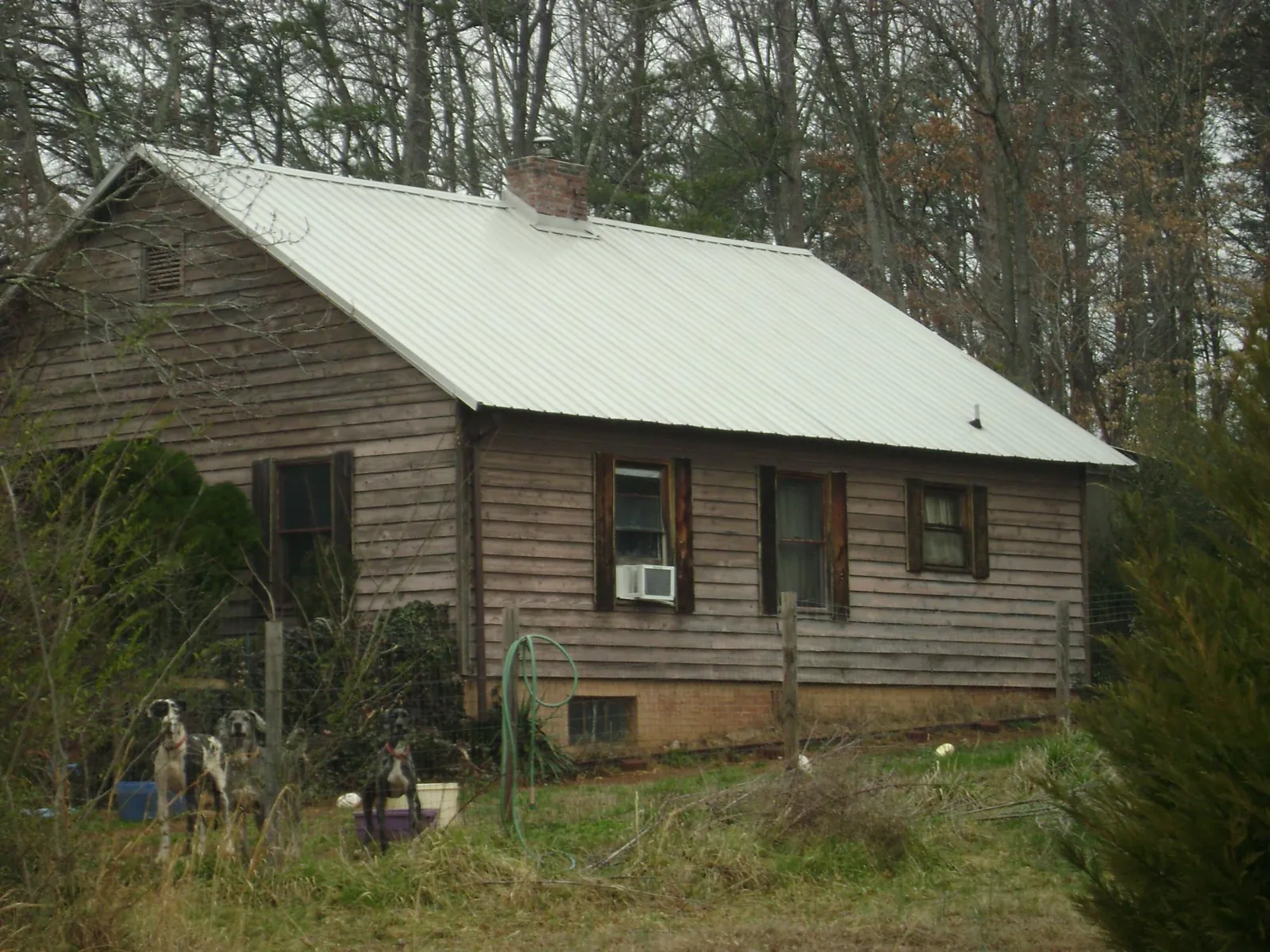 White metal roof on an old wood sided farmhouse, from a Asphalt Shingle Roof Repair job in Putnam Station